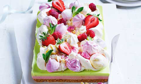 Smashed pavlova slice decorated with strawberries, cream and meringue kisses. 